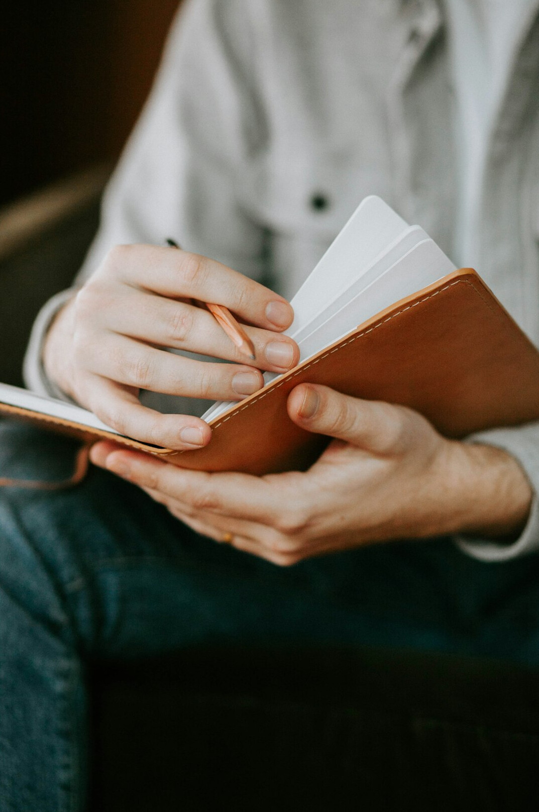 person writing in notebook
